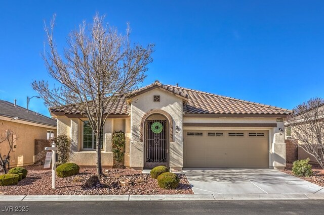 mediterranean / spanish-style house with a garage