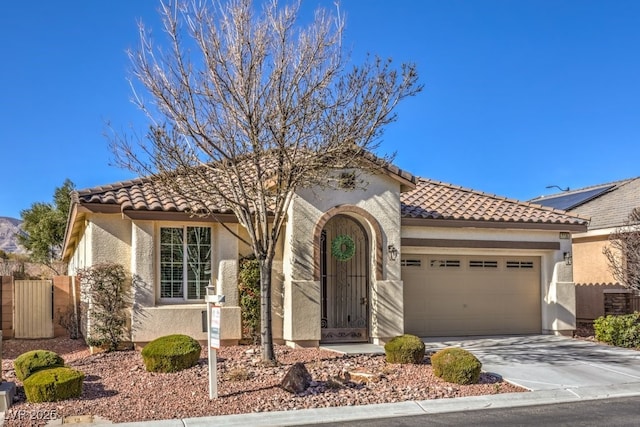 mediterranean / spanish-style house with a garage