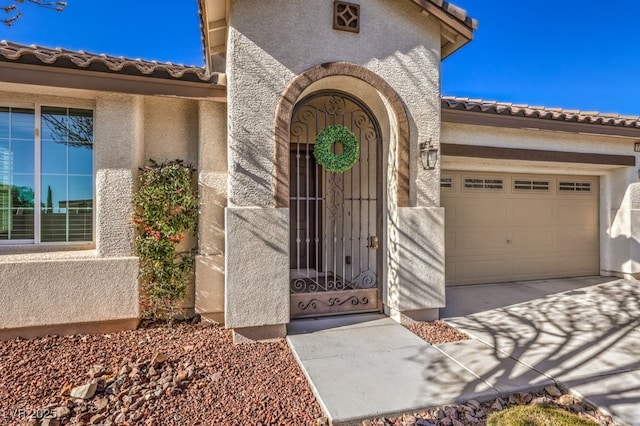 view of exterior entry featuring a garage