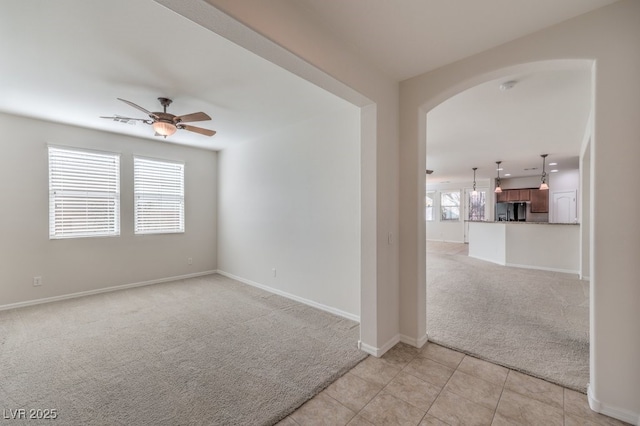 carpeted empty room with ceiling fan