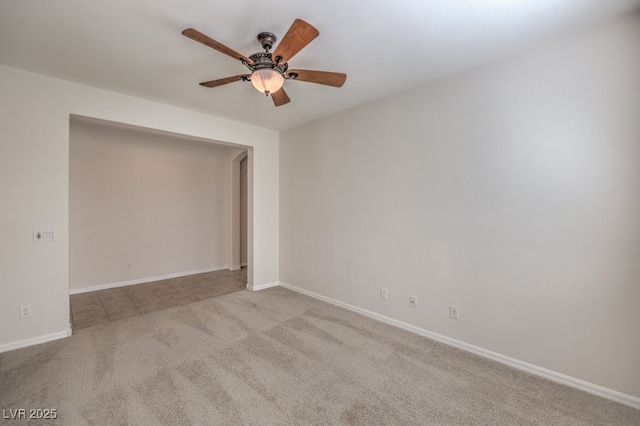 empty room featuring light colored carpet and ceiling fan