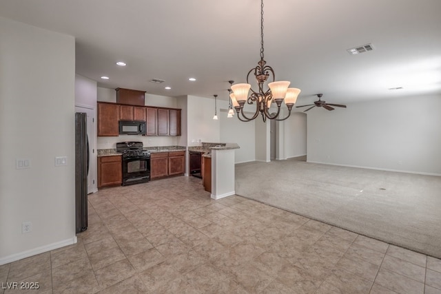 kitchen featuring light colored carpet, ceiling fan with notable chandelier, hanging light fixtures, and black appliances