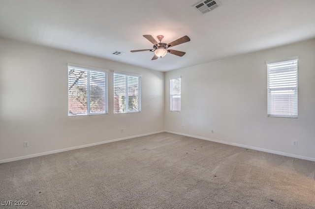 empty room with ceiling fan and carpet flooring