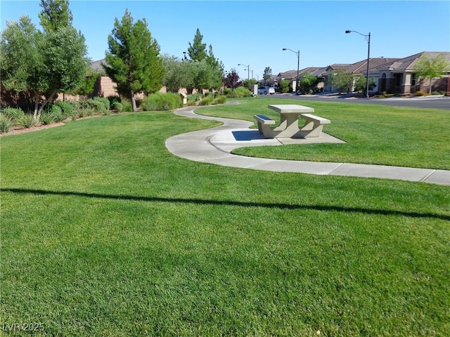 view of property's community with a lawn