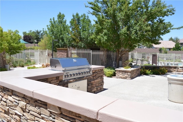 view of patio featuring an outdoor kitchen and a grill