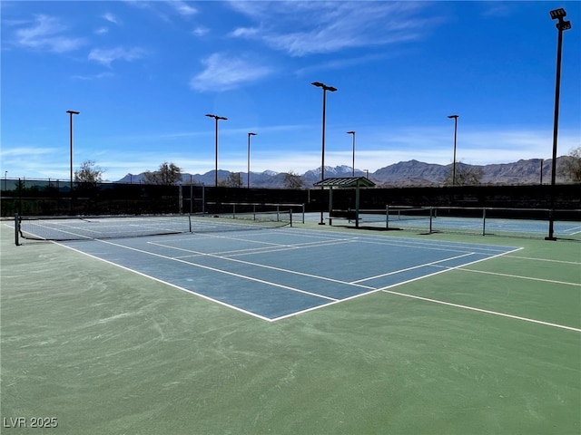 view of tennis court with a mountain view