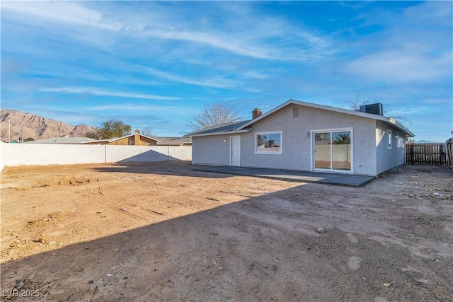 rear view of property featuring a mountain view