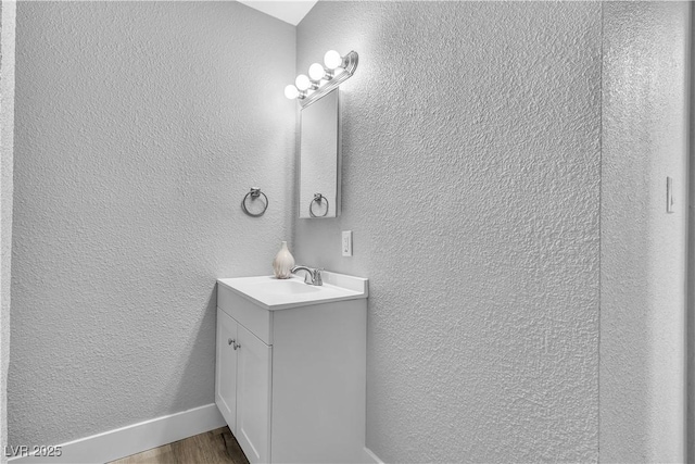 bathroom with hardwood / wood-style flooring and vanity