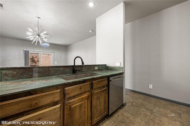 kitchen with pendant lighting, sink, a chandelier, and dishwasher