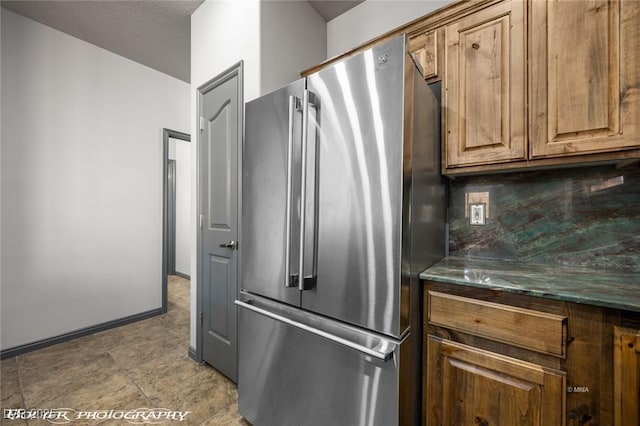 kitchen with tasteful backsplash and high end refrigerator