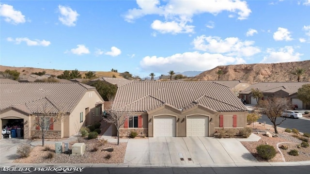 view of front of property with a garage and a mountain view