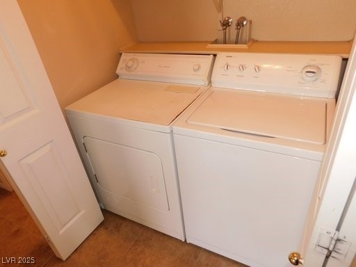 laundry room featuring laundry area, separate washer and dryer, and tile patterned floors