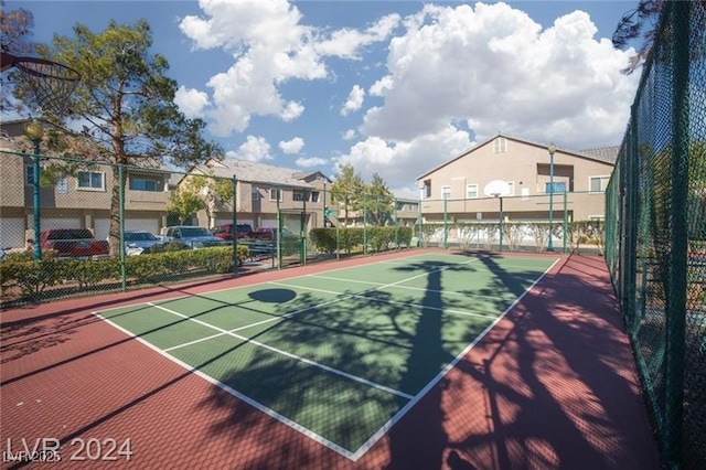 view of sport court with community basketball court, fence, and a residential view