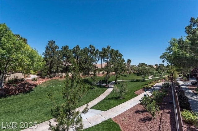 view of property's community featuring a yard