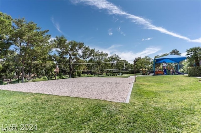 view of property's community with a lawn, playground community, and volleyball court