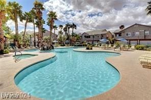 view of pool featuring a hot tub and a patio