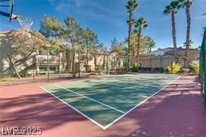 view of tennis court with community basketball court and fence