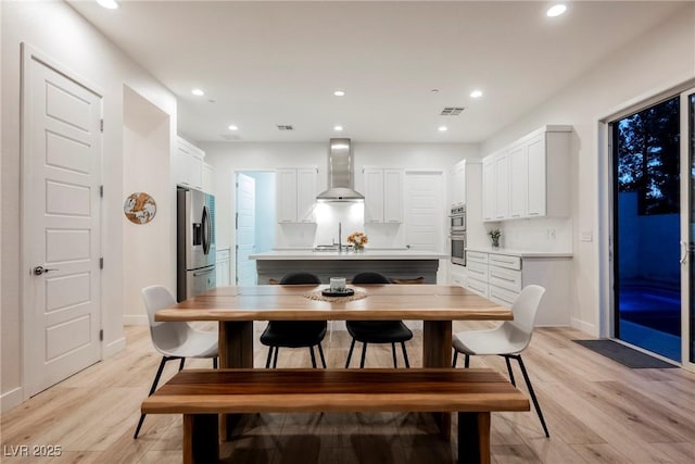 dining room with light hardwood / wood-style flooring