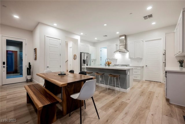 dining space with sink and light hardwood / wood-style flooring