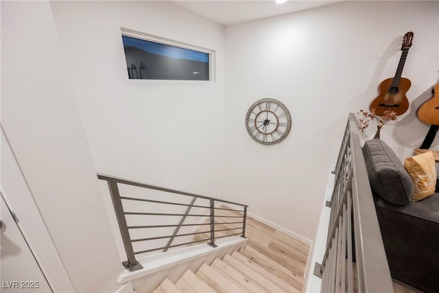 stairway with hardwood / wood-style floors