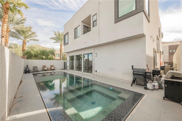 view of swimming pool with a grill, a patio area, and an in ground hot tub