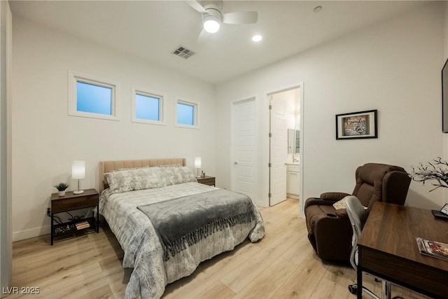 bedroom featuring ceiling fan, ensuite bathroom, and light wood-type flooring