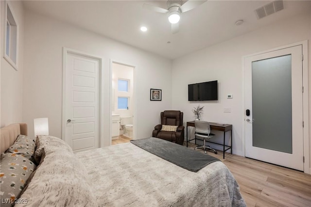 bedroom with ceiling fan, ensuite bathroom, and light hardwood / wood-style floors