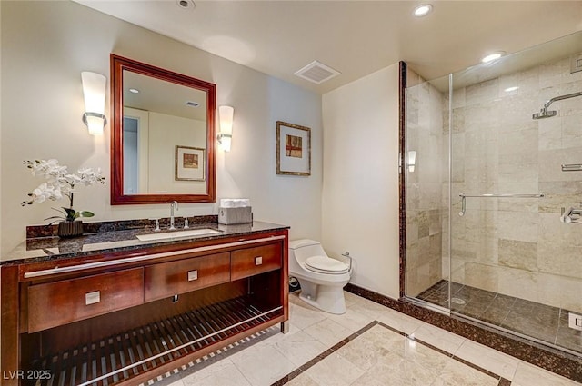 bathroom with a shower with door, vanity, and toilet