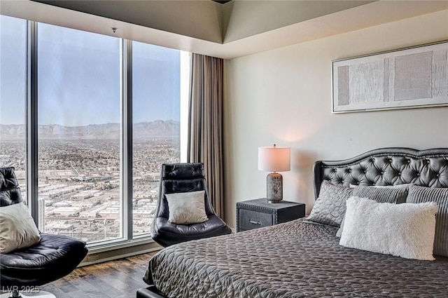 bedroom featuring a mountain view and hardwood / wood-style floors