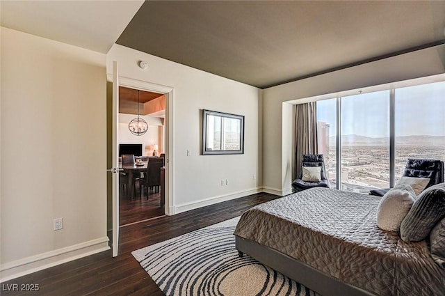 bedroom with dark wood-type flooring and access to exterior