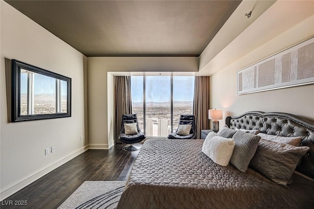 bedroom featuring access to exterior and dark wood-type flooring