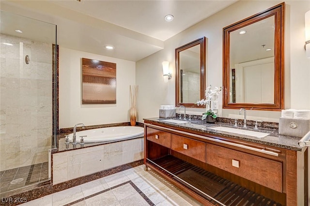 bathroom featuring vanity and independent shower and bath