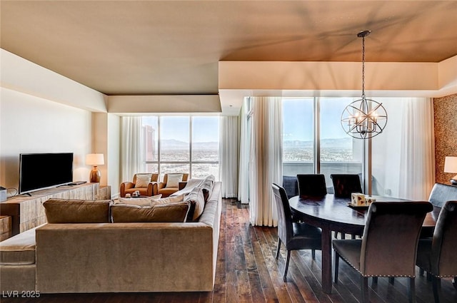 dining area featuring a mountain view, dark hardwood / wood-style floors, and an inviting chandelier