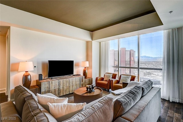 living room featuring plenty of natural light and dark hardwood / wood-style flooring