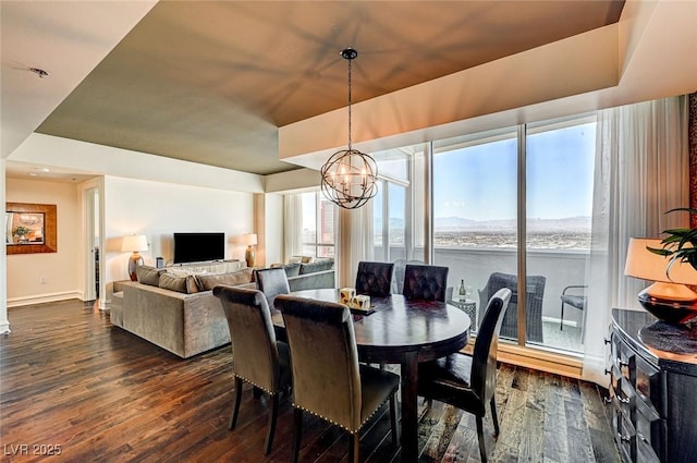 dining area with an inviting chandelier, plenty of natural light, and dark hardwood / wood-style floors