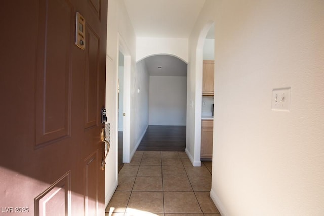 hallway featuring light tile patterned floors