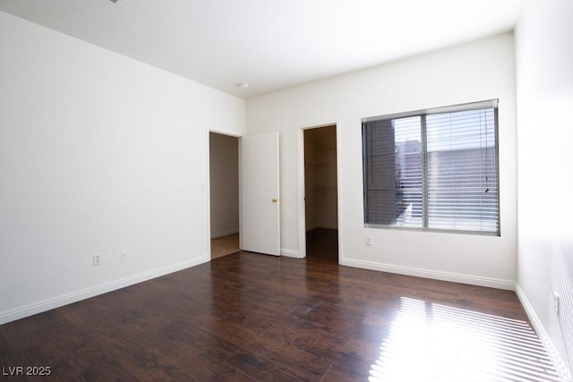 empty room with dark wood-type flooring