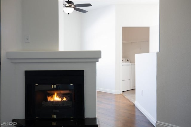 interior details featuring separate washer and dryer, hardwood / wood-style flooring, and ceiling fan