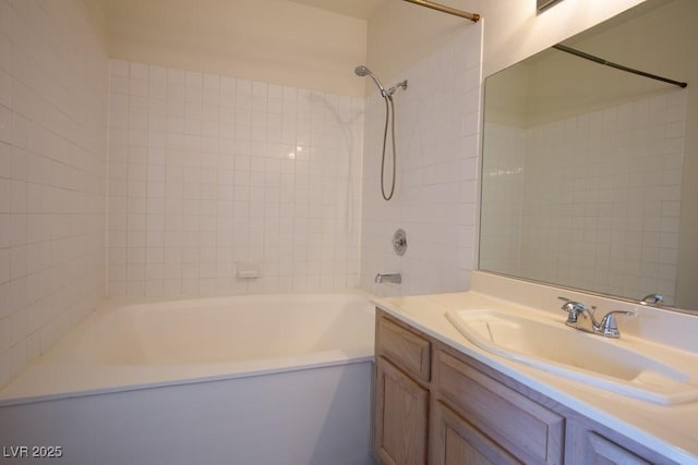 bathroom featuring vanity and tiled shower / bath combo