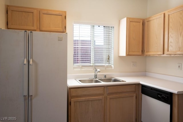 kitchen with sink, white appliances, and light brown cabinets