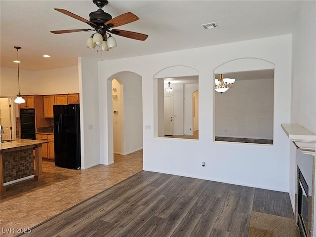 living room with ceiling fan, dark hardwood / wood-style floors, and sink