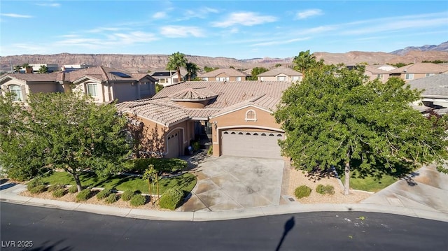 view of front of home with a mountain view and a garage