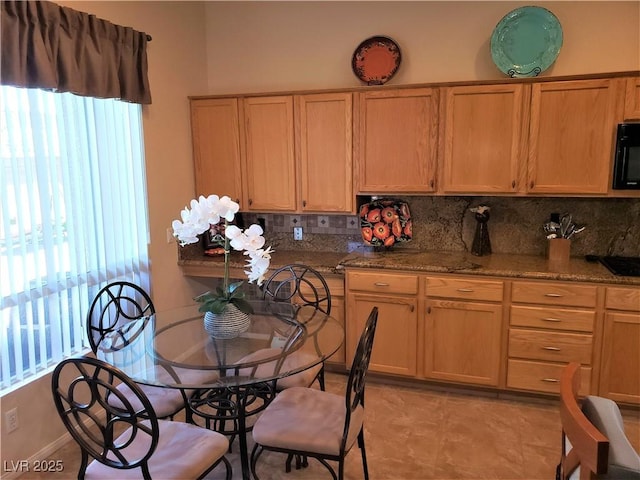 kitchen with stone countertops and decorative backsplash