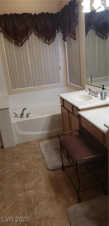 bathroom featuring vanity and a washtub