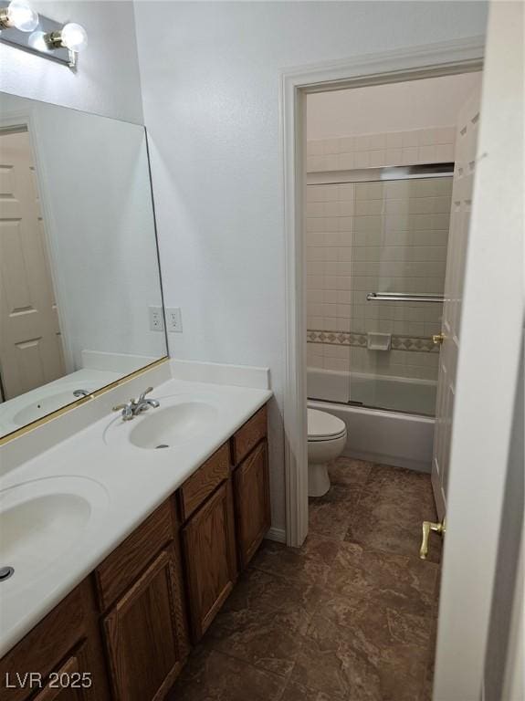 full bathroom with vanity, combined bath / shower with glass door, and toilet