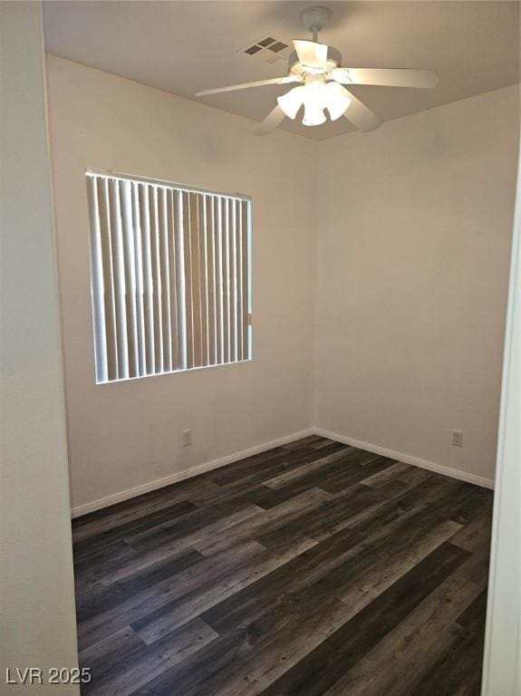 empty room with ceiling fan and dark hardwood / wood-style floors