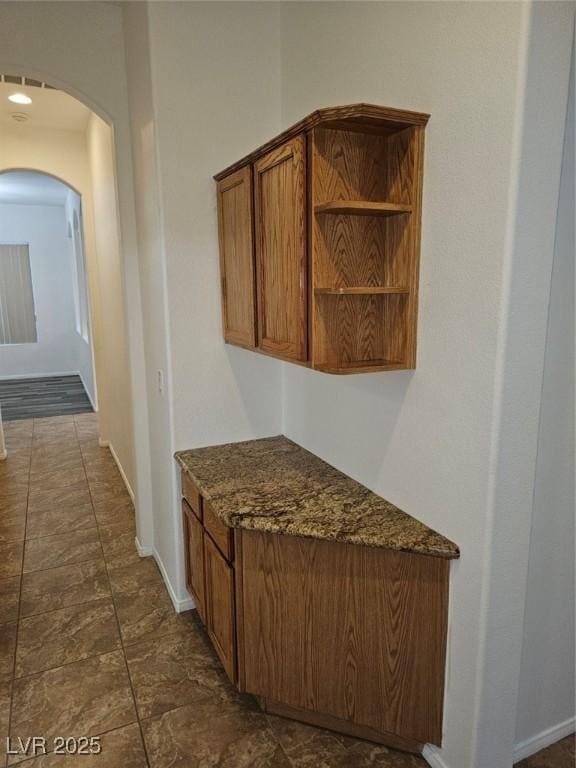 interior space with dark stone countertops