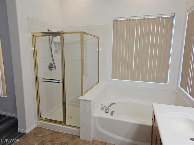 bathroom with independent shower and bath and vanity