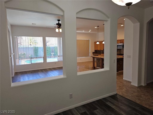 empty room featuring dark hardwood / wood-style floors and ceiling fan