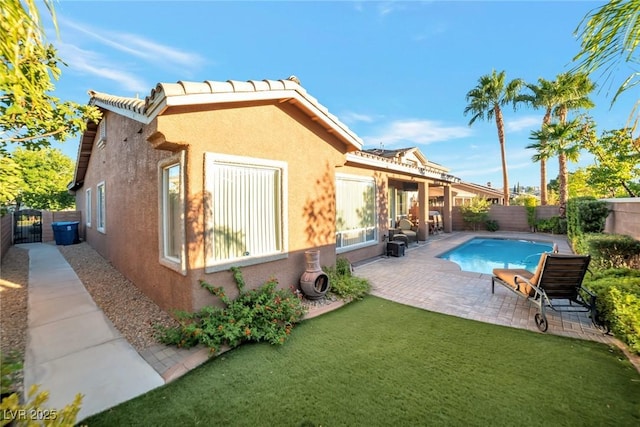 view of pool with a lawn and a patio